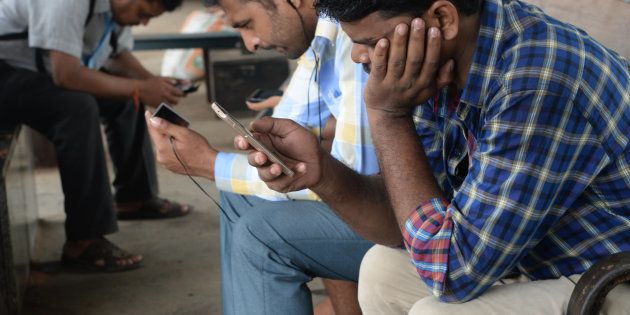 Indians surf the internet on their phones at a free wi-fi zone inside a suburban railway station in Mumbai.