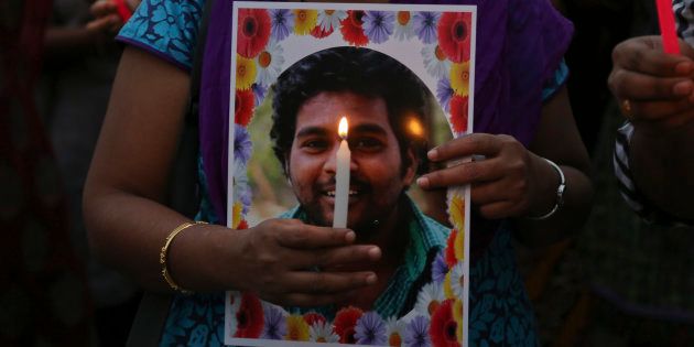 Activist of a Dalit organization participate in a candle light vigil holding photographs of Indian student Rohith Vemula in Hyderabad, India, Wednesday, Jan 20, 2016.