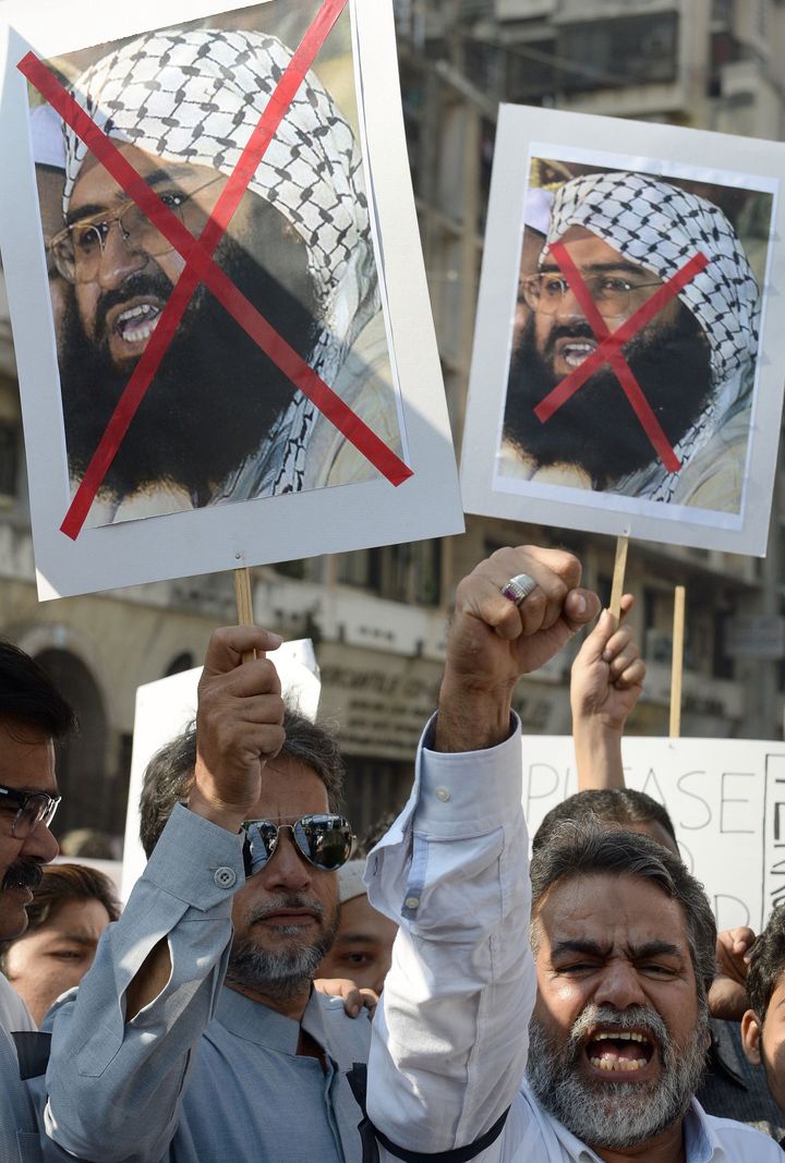 Indian activists carry placards of the chief of Jaish-e-Mohammad, Maulana Masood Azhar as they shout anti-Pakistan slogans.