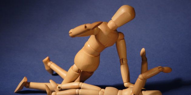Representative image of wooden dolls arranged in a fighting scene.