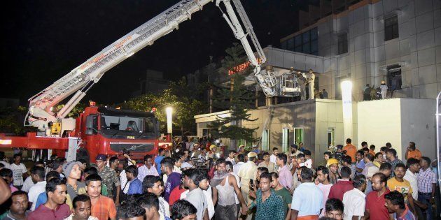 This photograph taken on October 17, shows Indian rescue workers trying help victims of a massive fire at the SUM hospital building in Bhubaneswar, the capital of coastal Odisha state.