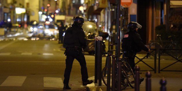 Policemen patrol near the Bataclan Theatre, one of the site of the attacks in Paris on November 15, 2015.