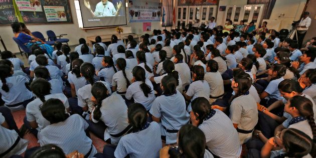Students in Ahmadabad watch Prime Minister Narendra Modi on screen as he speaks during a nationwide address during Teachers' Day on September 5, 2014. REUTERS/Amit Dave