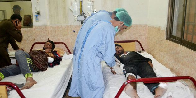 Medical workers treat an injured policeman at hospital after militants attacked the Balochistan Police College in Quetta on October 25, 2016.