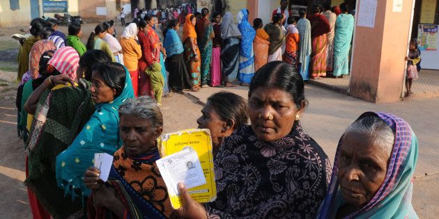 Voters showing their ID cards at a polling booth during the first phase of assembly elections of Chhattisgarh in Jagadalpur, November 2013, in Bastar. (Photo by Parwaz Khan/Hindustan Times via Getty Images)