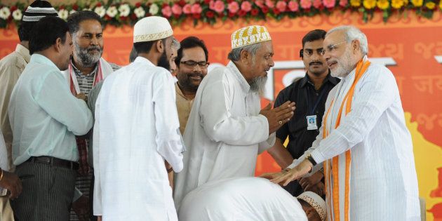 Indian Muslims greetNarendra Modi (R) at the Gujarat University Convention Centre in Ahmedabad on September 17, 2011.