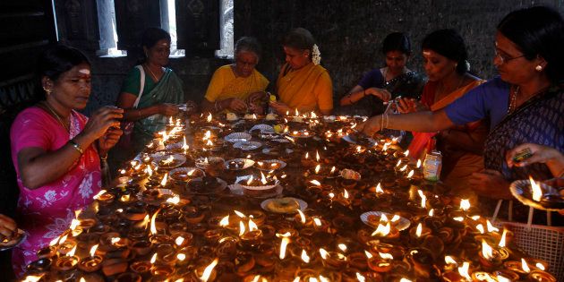 Devotees light earthen oil lamps as they pray to celebrate the Aadi Krithigai festival at a temple in Chennai on 21 July 2014. During the festival, Hindu women fast for the whole day in hope of winning the favour of Lord Muruga. REUTERS/Babu