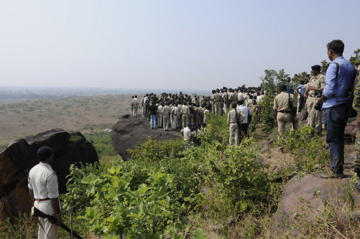 Policemen surround the area where eight SIMI terrorist were killed in an encounter lying on ground at Acharpura on October 31, 2016 in Bhopal.