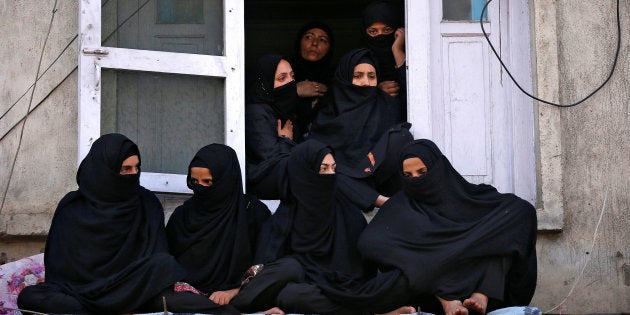 Kashmiri Shi'ite Muslim women watch a Muharram procession marking Ashura in Srinagar October 12, 2016.