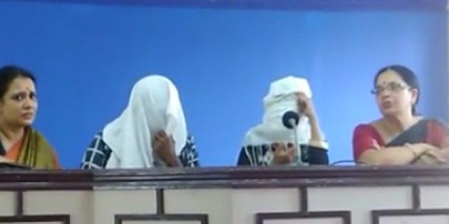The gang rape survivor addresses a press conference along with her husband. Their faces have been covered to conceal their identity.