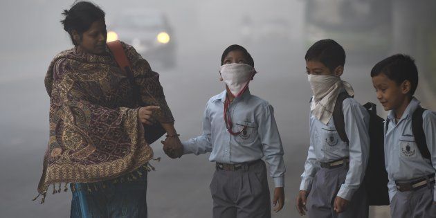 School children taking precautions as city covered under a blanket of heavy smog, air quality deteriorated sharply overnight leading to poor visibility conditions across the city, on November 3, 2016 in New Delhi, India.