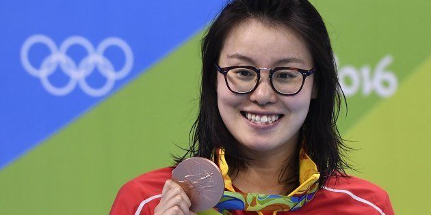 China's Fu Yuanhui poses with her bronze medal on the podium of the Women's 100m Backstroke during the swimming event at the Rio 2016 Olympic Games at the Olympic Aquatics Stadium in Rio de Janeiro on August 8, 2016. / AFP / GABRIEL BOUYS (Photo credit should read GABRIEL BOUYS/AFP/Getty Images)