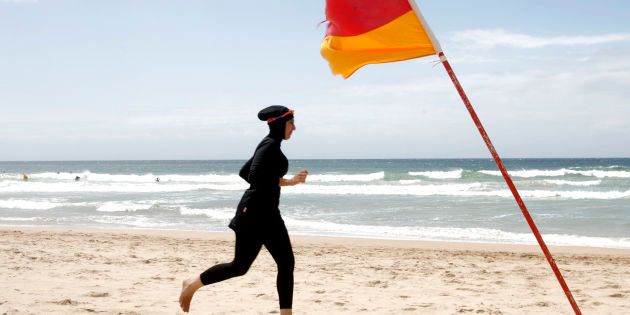 Twenty-year-old trainee volunteer surf life saver Mecca Laalaa runs along North Cronulla Beach in Sydney during her Bronze medallion competency test January 13, 2007. Specifically designed for Muslim women, Laalaa's body-covering swimming costume has been named the