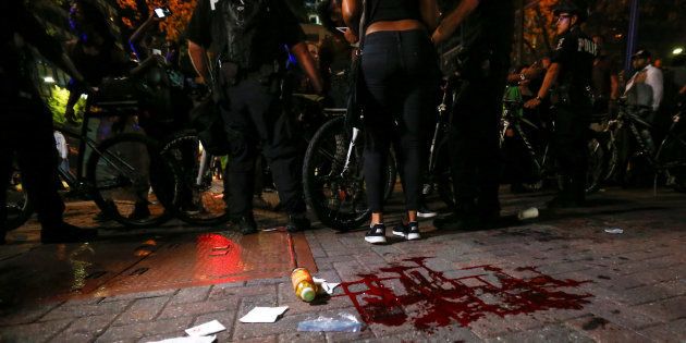 Blood covers the pavement where a person was shot in uptown Charlotte, NC during a protest of the police shooting of Keith Scott, in Charlotte, North Carolina, U.S. September 21, 2016. REUTERS/Jason Miczek