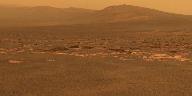 A portion of the west rim of Endeavour crater sweeps southward in this color view from NASA's Mars Exploration Rover Opportunity released by NASA August 10, 2011. This crater has a diameter of about 14 miles (22 km). This view combines exposures taken by Opportunity's panoramic camera (Pancam) of the rover's work on Mars August 6, 2011. Opportunity arrived at the rim during its next drive on August 9, 2011. Endeavour crater has been the rover team's destination for Opportunity since the rover finished exploring Victoria crater in August 2008. Endeavour offers access to older geological deposits than any Opportunity has seen before. The lighter-toned rocks closer to the rover in this view are similar to the rocks Opportunity has driven over for most of the mission. However, the darker-toned and rougher rocks just beyond that might be a different type for Opportunity to investigate. The ground in the foreground is covered with iron-rich spherules, nicknamed