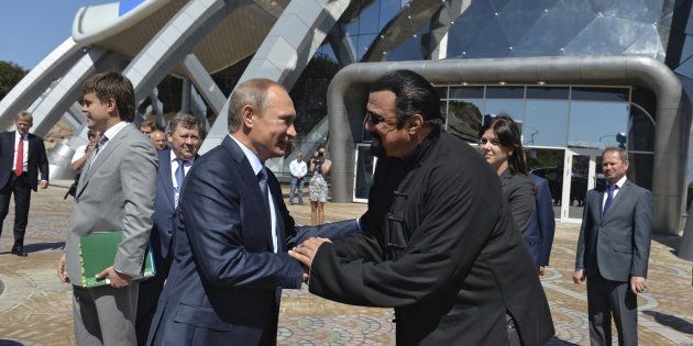 Russian President Vladimir Putin (L) shakes hands with U.S. actor Steven Seagal while visiting an oceanarium at Russky Island in the far eastern city of Vladivostok, Russia, September 4, 2015. Putin urged domestic and foreign investors on Friday to help develop Russia's vast Far East region, promising high returns and reassuring Asia-Pacific economies about their strategic importance. REUTERS/Alexei Druzhinin/RIA Novosti/Kremlin ATTENTION EDITORS - THIS IMAGE HAS BEEN SUPPLIED BY A THIRD PARTY. IT IS DISTRIBUTED, EXACTLY AS RECEIVED BY REUTERS, AS A SERVICE TO CLIENTS.