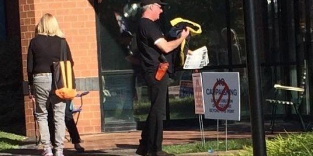 A man carrying a weapon outside of Loudoun County Registrars Office in Leesburg, Virginia.