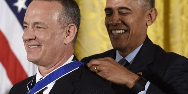 US President Barack Obama presents actor Tom Hanks with the Presidential Medal of Freedom, the nation's highest civilian honor, during a ceremony honoring 21 recipients, in the East Room of the White House in Washington, DC, November 22, 2016. / AFP / SAUL LOEB (Photo credit should read SAUL LOEB/AFP/Getty Images)