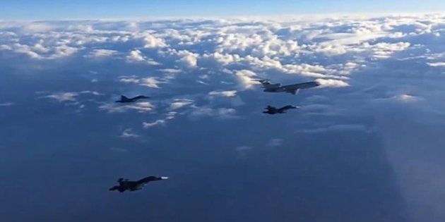 SYRIA. MARCH 15, 2016. A Tupolev Tu-154 airliner and Sukhoi Su-34 fighter bombers on their way from the Hmeymim air base to their permanent base in Russia. On March 14, 2016, Russian President Vladimir Putin gave an order to start the withdrawal of the main part of Russian forces from Syria. Video screen grab. Russian Defence Ministry's Press and Information Department/TASS (Photo by TASS\TASS via Getty Images)