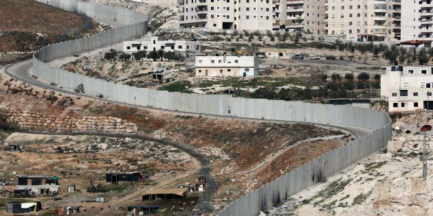 A picture taken on February 6, 2017 shows Israel's controversial separation barrier dividing east Jerusalem (L) from the West Bank village of Anata (R). / AFP / THOMAS COEX (Photo credit should read THOMAS COEX/AFP/Getty Images)