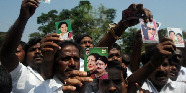 Members of the All India Anna Dravida Munnetra Kazhagam (AIADMK) party display portraits of VK Sasikala and former Tamil Nadu Chief Minister Jayalalithaa Jayaram, as they celebrate in front of the governors residence after AIADMK leader Edapadi Palanisamy was called to be sworn in as Chief minister of Tamil Nadu in Chennai on February 16, 2017. / AFP / ARUN SANKAR (Photo credit should read ARUN SANKAR/AFP/Getty Images)