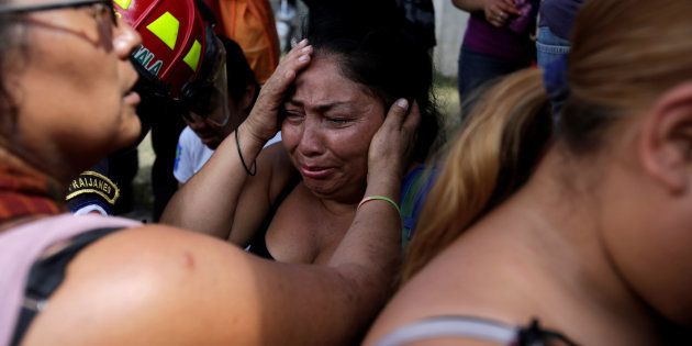 Family members react as they wait for news of their loved ones after a fire broke at the Virgen de Asuncion home in San Jose Pinula, on the outskirts of Guatemala City, Guatemala March 8, 2017.