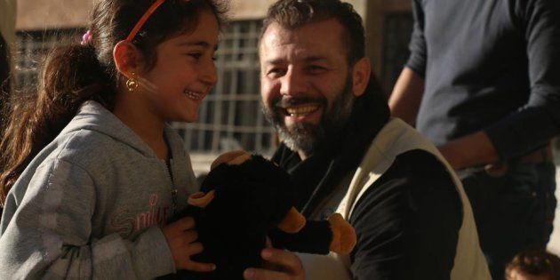Rami hands out toys to Syrian Children