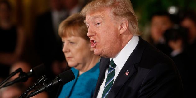 U.S. President Donald Trump speaks as German Chancellor Angela Merkel listens as they hold a joint news conference in the East Room of the White House in Washington, U.S., March 17, 2017. REUTERS/Jonathan Ernst