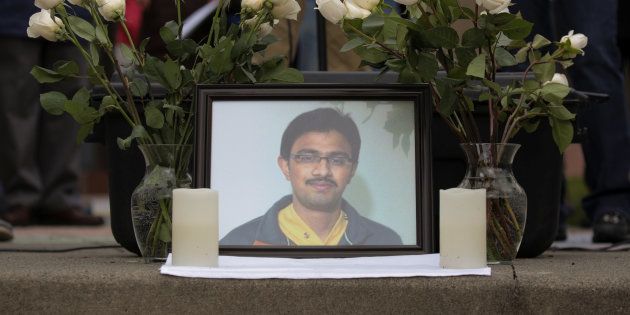 A picture of Srinivas Kuchibhotla, an immigrant from India who was recently shot and killed in Kansas, is surrounded by roses during a vigil in honor of him at Crossroads Park in Bellevue, Washington, U.S. March 5, 2017.
