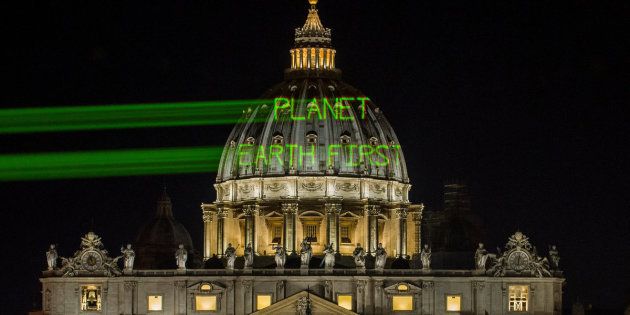 A few hours before the meeting between Pope Francis and President Donald Trump, Greenpeace activists send a message on the dome of St. Peter's Basilica early Wednesday.