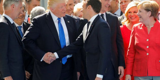 U.S. President Donald Trump jokes with French President Emmanuel Macron about their handshakes in front of NATO leaders, including German Chancellor Angela Merkel, NATO Secretary General Jens Stoltenberg (2ndR) and Belgium King Philippe (L), at the start of the NATO summit at their new headquarters in Brussels, Belgium, May 25, 2017. REUTERS/Jonathan Ernst TPX IMAGES OF THE DAY