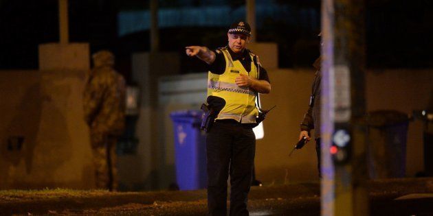 An armed police officer at the scene in the Melbourne bayside suburb of Brighton on Monday night.