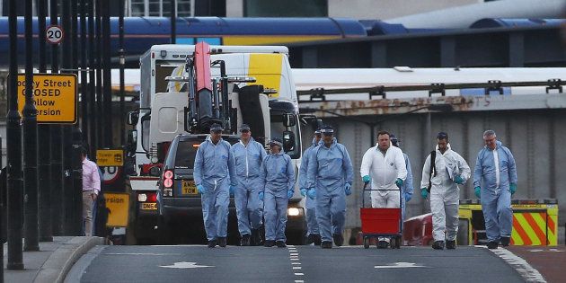 Forensics investigators work as a white van is carried away from London Bridge, after attackers rammed a hired van into pedestrians on London Bridge and stabbed others nearby killing and injuring people, in London, Britain June 4, 2017. REUTERS/Neil Hall