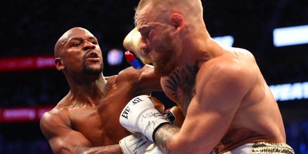 Aug 26, 2017; Las Vegas, NV, USA; Floyd Mayweather Jr. lands a hit against Conor McGregor during their boxing match at the at T-Mobile Arena. Mandatory Credit: Mark J. Rebilas-USA TODAY Sports