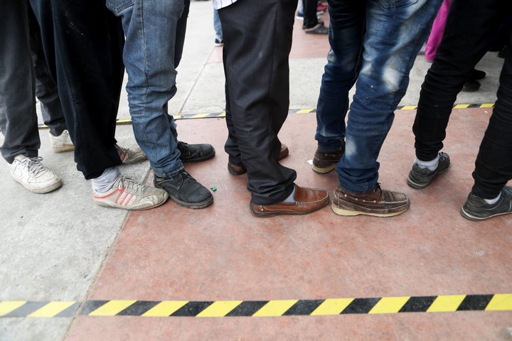 Migrants wait in a plaza at Tijuana's El Chaparral border crossing to place their names on a list to be allowed to cross into the U.S. to petition for asylum on Nov. 28.