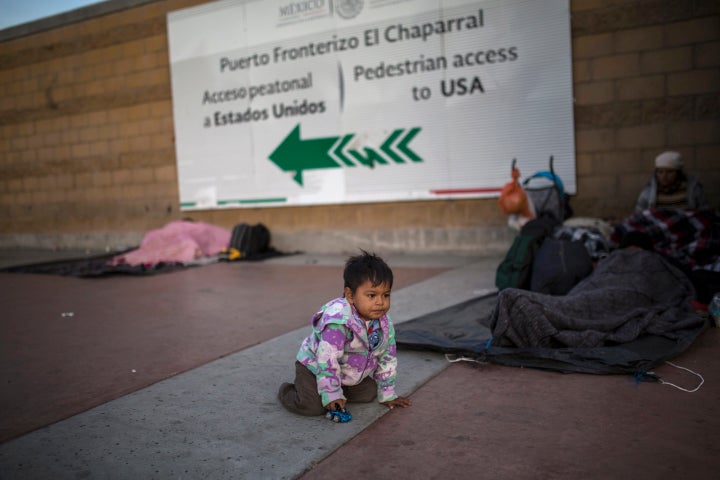 Steven Aguila, 2, from El Salvador, plays with a toy car at El Chaparral border crossing in Tijuana, Mexico, on Nov. 23.