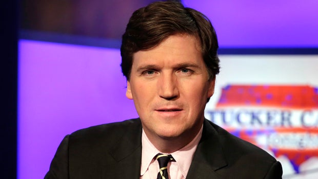Tucker Carlson, host of "Tucker Carlson Tonight," poses for photos in a Fox News Channel studio, in New York, Thursday, March 2, 2107. (AP Photo/Richard Drew)
