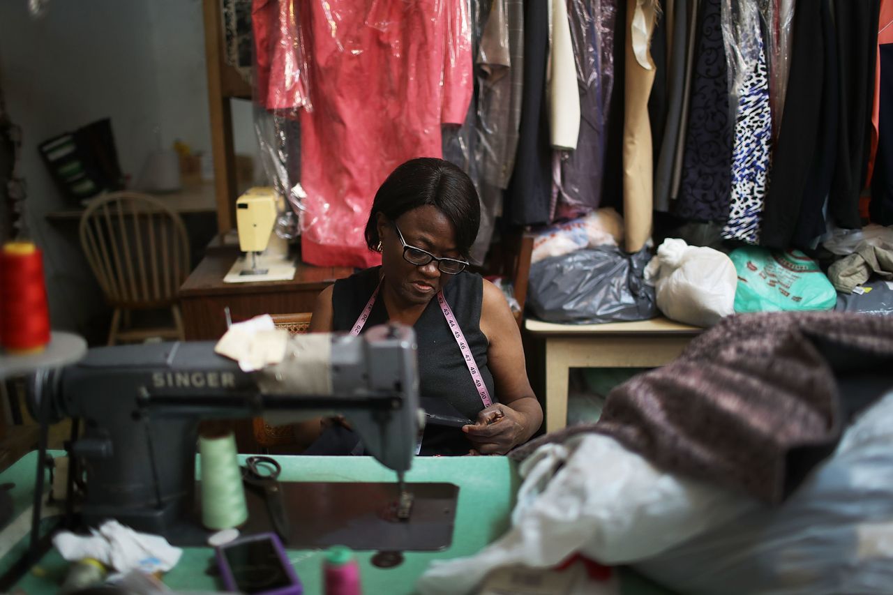 Juliette Virgile works in the tuxedo store in the Little Haiti neighborhood, Miami, which has been in her family for 32 years. Little Haiti and surrounding neighborhoods are experiencing gentrification, which is slowly pushing out some of the longtime residents and business owners.