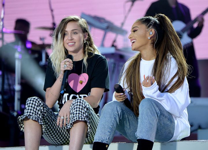 Miley Cyrus and Ariana Grande perform on stage together at the One Love Manchester benefit concert. 