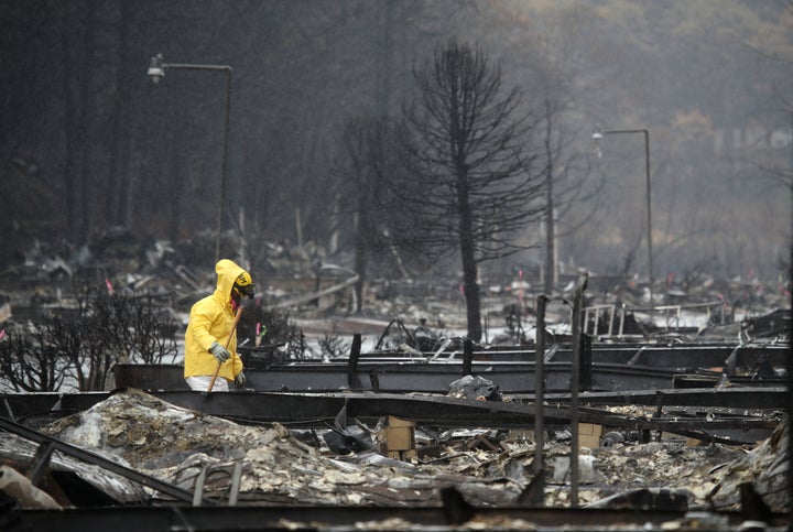 A search and rescue crew member searches for human remains at a mobile home park that was destroyed by the Camp Fire in California last month. 