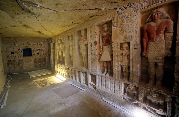 The walls are decorated with hieroglyphs and statues of pharaohs.