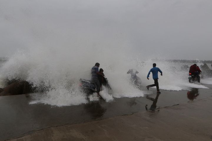 High waves hit the Kasimedu harbor on the Bay of Bengal coast in Chennai, India, Sunday, Dec. 16, 2018.