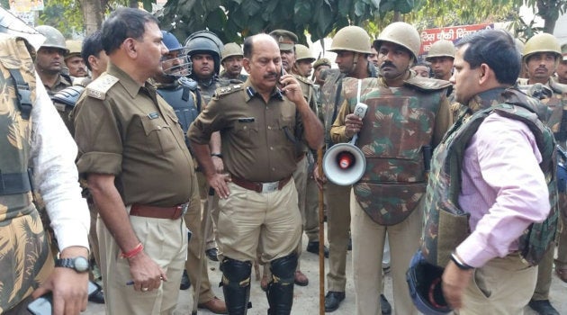 Policemen gather following reports of mob violence at Chingravati in Bulandhahr.