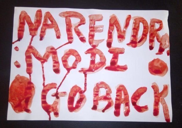 Demonstrators wrote "Narendra Modi Go Back" in blood to protest the loss of their lands to the Sardar Patel Unity Statue