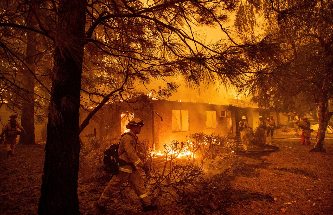 Firefighters work to keep flames from spreading through the Shadowbrook apartment complex as a wildfire burns through Paradise, California, in November.