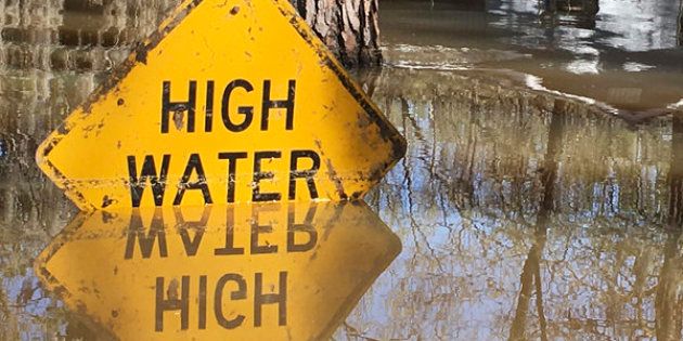 A high water sign is submerged near Lake Bistineau in Webster Parish, Louisiana March 14, 2016. The death toll from storms in Southern U.S. states rose to five as storm-weary residents of Louisiana and Mississippi watched for more flooding on Monday from drenching rains that inundated homes, washed out roads and prompted thousands of rescues. REUTERS/Therese Apel TPX IMAGES OF THE DAY