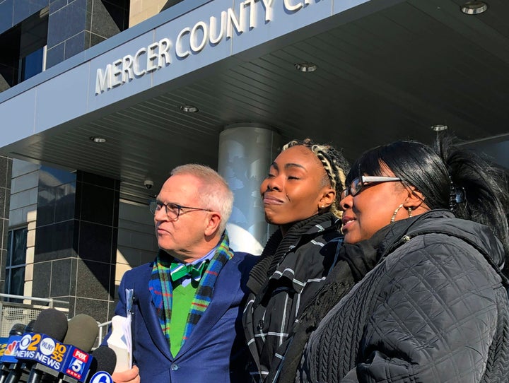 Jazmine Headley, center, joins attorney Brian Neary and her mother, Jacqueline Jenkins, outside a courthouse in Trenton, New Jersey. Prosecutors ultimately dropped charges against Headley after a confrontation with police and security guards at a public benefits office.