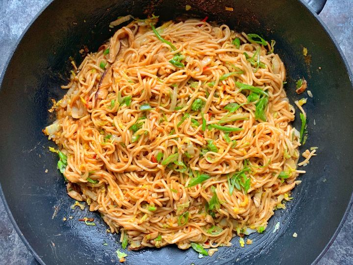 Fresh lo mein noodles are stir-fried with mushrooms, cabbage and bok choy in a rich and spicy peanut sauce laced with soy and honey.