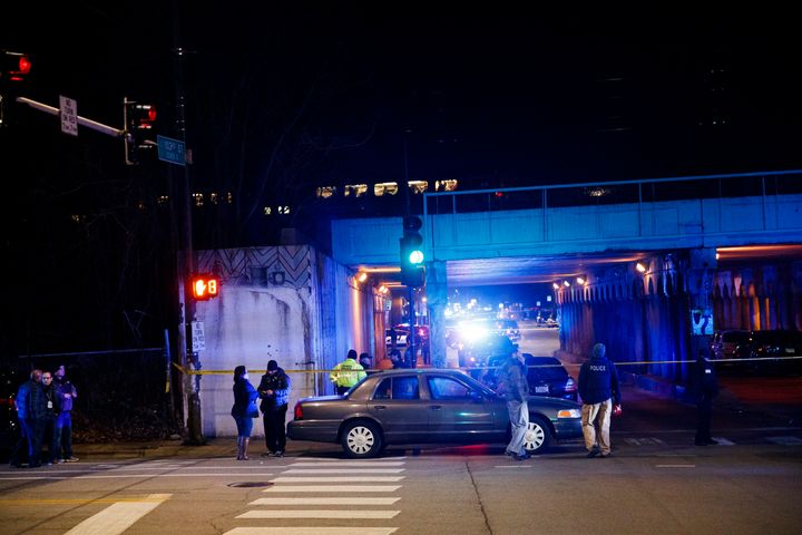 Police investigate the scene where two officers were killed after they were struck by a South Shore train near 103rd Street and Dauphin Avenue in Chicago on Monday.