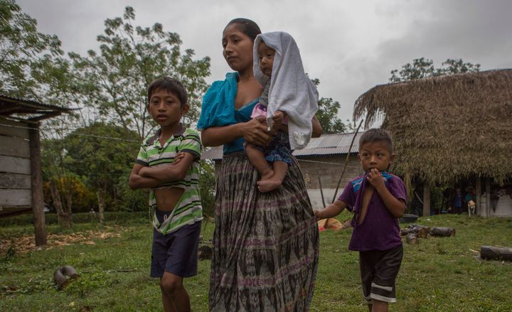 Claudia Maquin, 27, walks with her three children, Abdel, 9, left, Angela, 6 months, middle, and Elvis, 5, right, as they leave her father-in-law's house, in Raxruha, Guatemala, on Dec. 15, 2018. Her daughter, 7-year-old Jakelin Caal, died in a Texas hospital after being taken into custody by border patrol agents in New Mexico.
